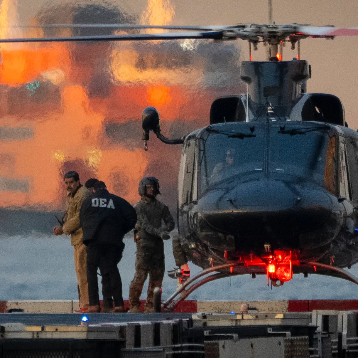 A fisherman mends nets on a pier that once stood 50 meters from the shoreline